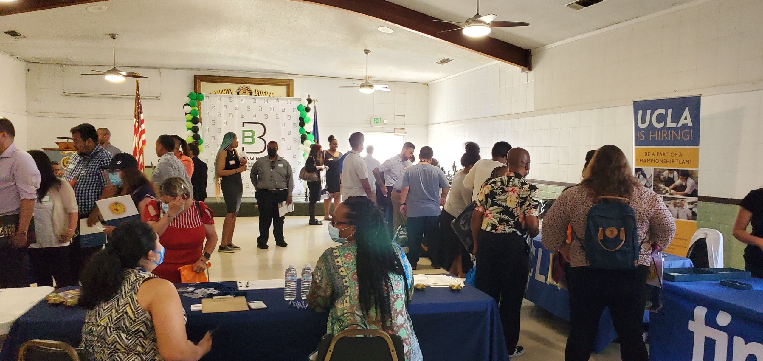 Breaking Barriers Job Fair - people inside walking by each table talking